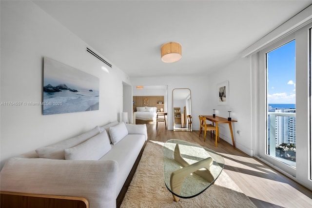 living room with wood finished floors and visible vents