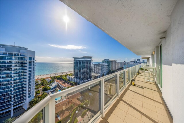 balcony with a view of city and a water view