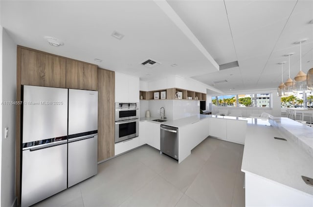 kitchen featuring visible vents, open shelves, appliances with stainless steel finishes, modern cabinets, and a sink