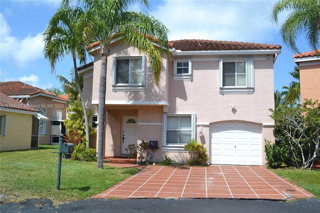 view of front facade featuring an attached garage, stucco siding, a front lawn, concrete driveway, and a tile roof