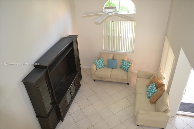 living area featuring light tile patterned flooring, plenty of natural light, and ceiling fan