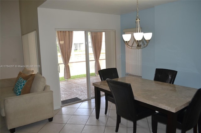 dining area with light tile patterned flooring and a chandelier