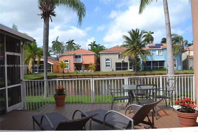 wooden deck featuring outdoor dining area and a residential view