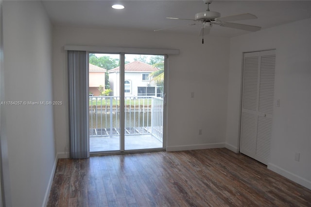 unfurnished room with baseboards, wood finished floors, and a ceiling fan