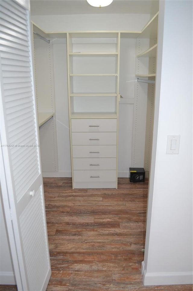 walk in closet featuring dark wood-style floors