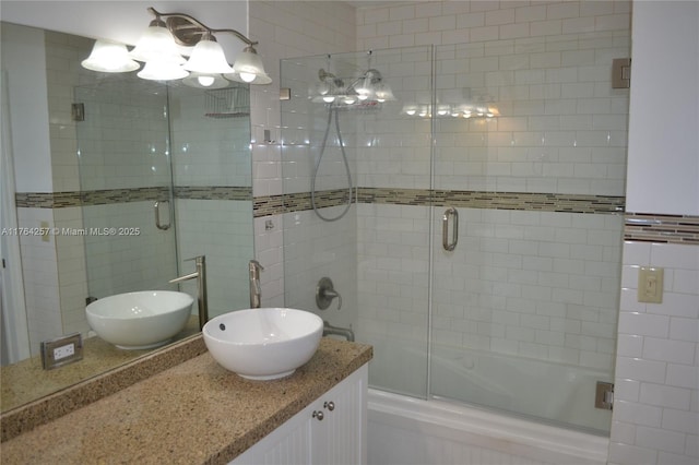 full bathroom featuring vanity and bath / shower combo with glass door