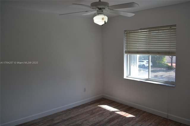 empty room with wood finished floors, baseboards, and ceiling fan