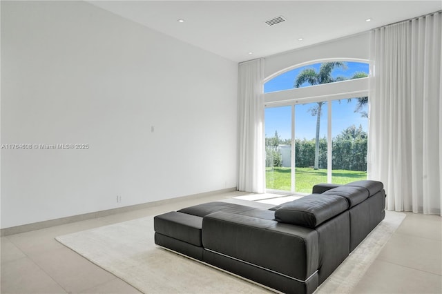 living area featuring recessed lighting, baseboards, visible vents, and light tile patterned flooring