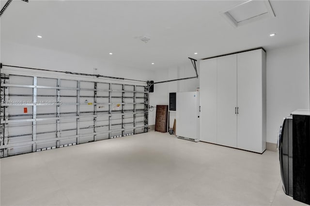 garage with electric panel and recessed lighting