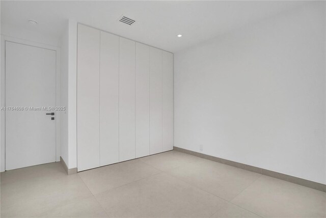 3234 SW 53rd Ct, Hollywood, FL 33312 - unfurnished bedroom with light tile patterned floors, a closet, and baseboards