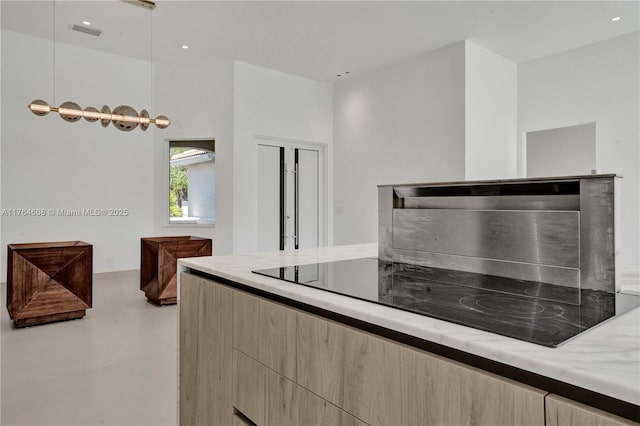 3234 SW 53rd Ct, Hollywood, FL 33312 - kitchen featuring concrete floors, light brown cabinets, modern cabinets, and decorative light fixtures