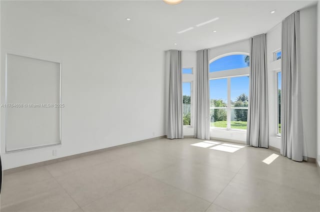 3234 SW 53rd Ct, Hollywood, FL 33312 - spare room featuring a towering ceiling and tile patterned floors