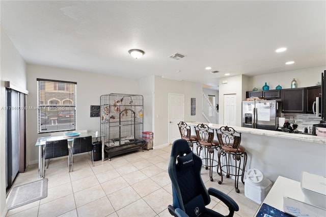 interior space featuring stairway, light tile patterned floors, visible vents, baseboards, and recessed lighting