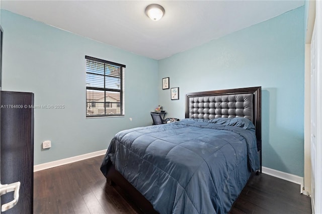 bedroom with baseboards and wood finished floors