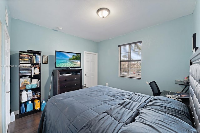 bedroom with dark wood finished floors