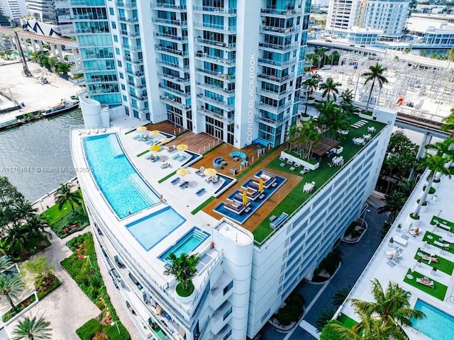 drone / aerial view featuring a view of city and a water view