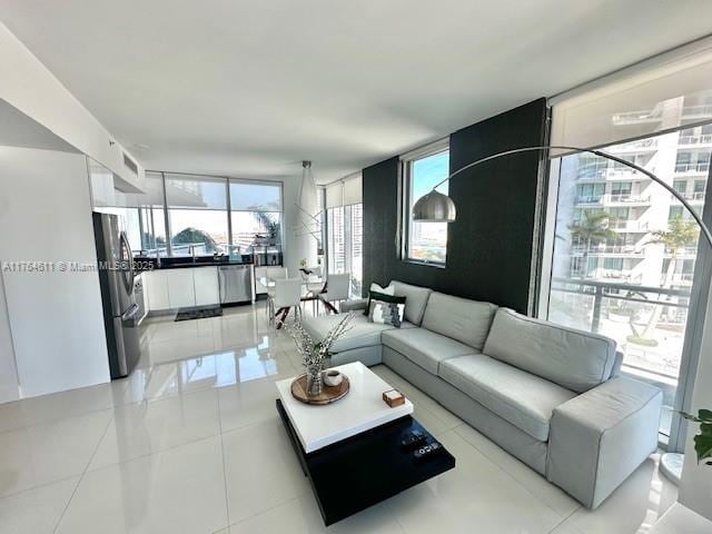 living area with a wall of windows and light tile patterned flooring