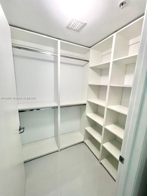 walk in closet with visible vents