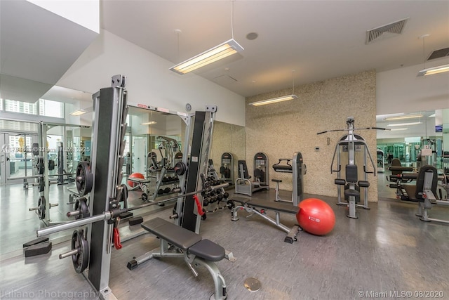 workout area featuring a high ceiling and visible vents