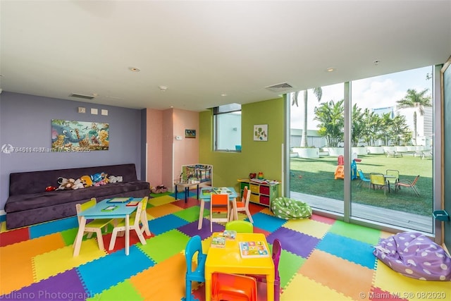 game room featuring visible vents and floor to ceiling windows