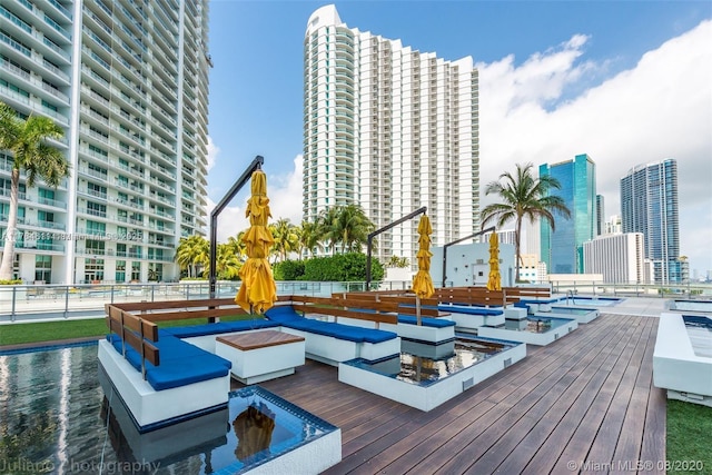 wooden terrace featuring a city view