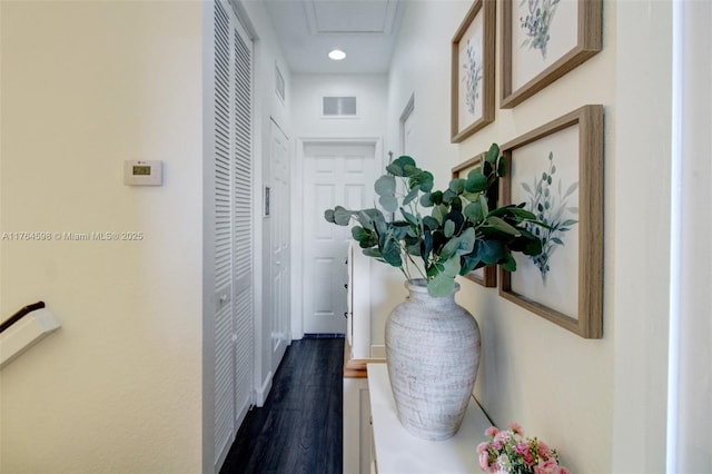 hallway featuring visible vents and dark wood-type flooring