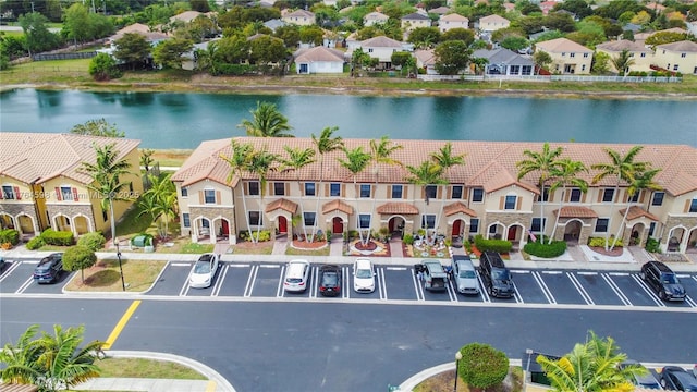 drone / aerial view featuring a residential view and a water view