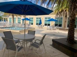 view of patio featuring outdoor dining area and a community pool