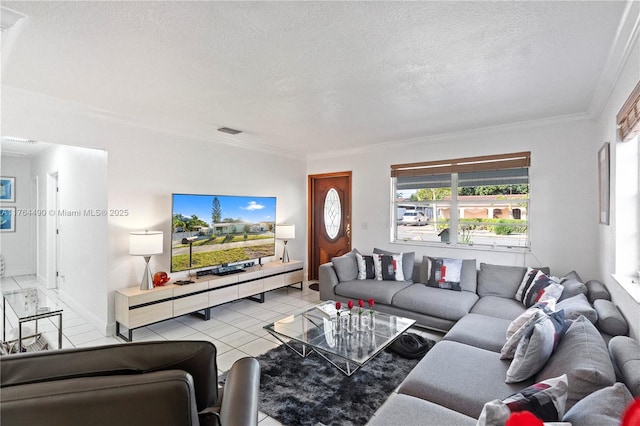 living area featuring ornamental molding, light tile patterned floors, visible vents, and a textured ceiling