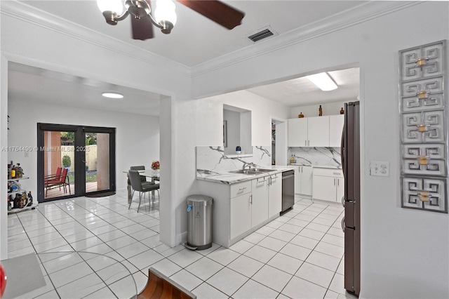 kitchen featuring visible vents, dishwasher, light countertops, freestanding refrigerator, and light tile patterned flooring