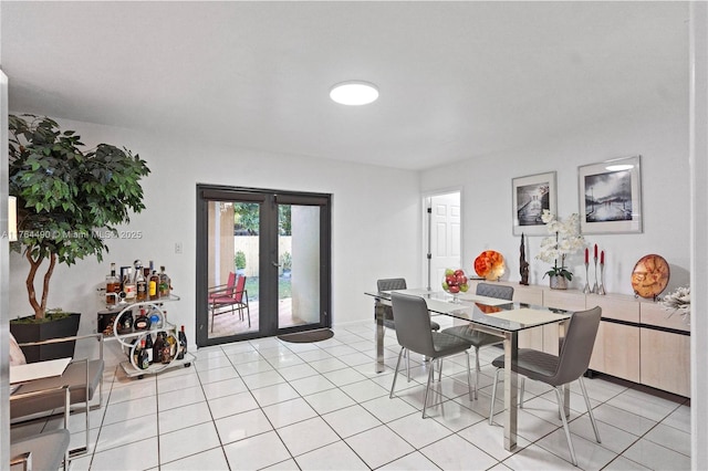 dining room with light tile patterned floors and french doors