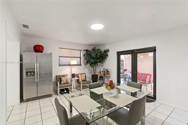 dining room with light tile patterned floors, baseboards, and visible vents