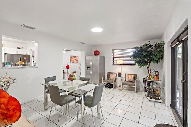 dining area featuring visible vents, baseboards, and light tile patterned flooring