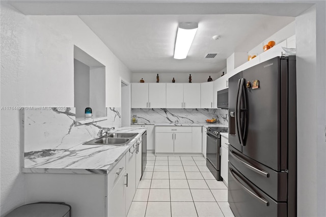 kitchen featuring visible vents, a sink, black appliances, white cabinets, and light countertops