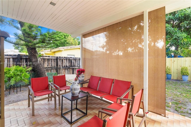 view of patio / terrace with an outdoor living space and fence