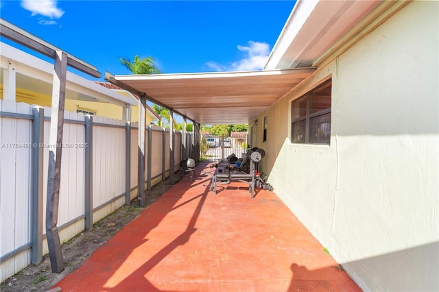 view of patio / terrace featuring an attached carport and fence