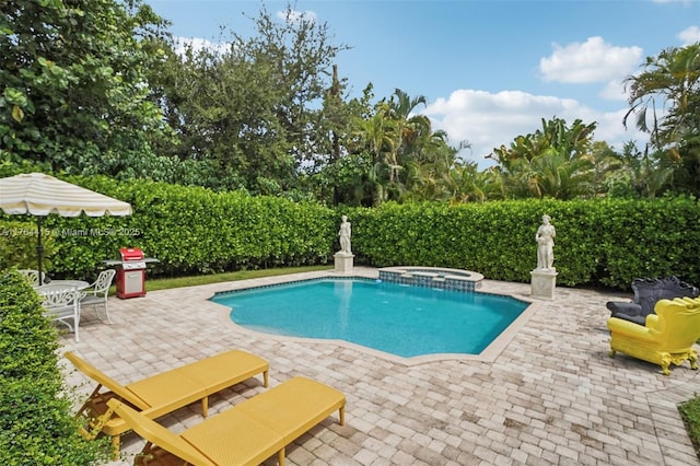 view of swimming pool featuring a patio and a pool with connected hot tub