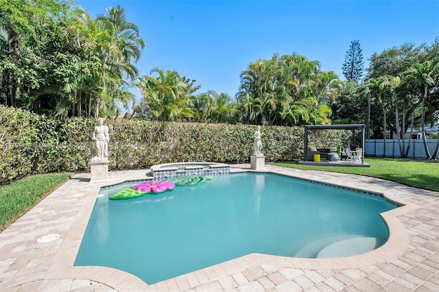 view of pool with a lawn, a pool with connected hot tub, a fenced backyard, and a patio area