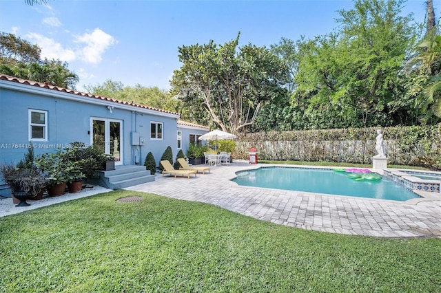 view of pool featuring a fenced in pool, fence, a yard, french doors, and a patio area