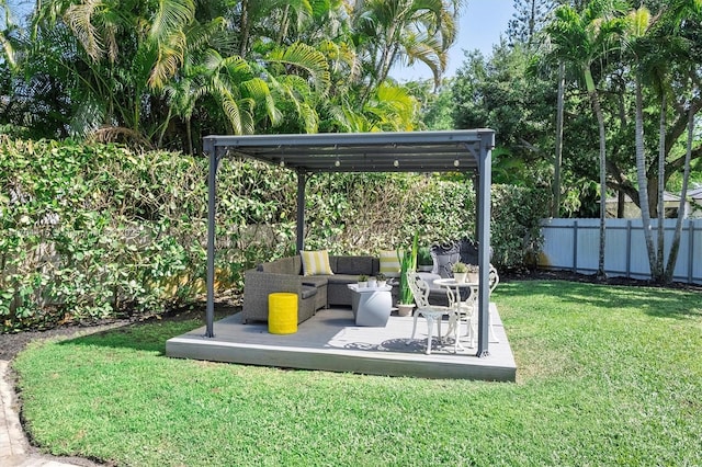 view of yard with outdoor lounge area and fence