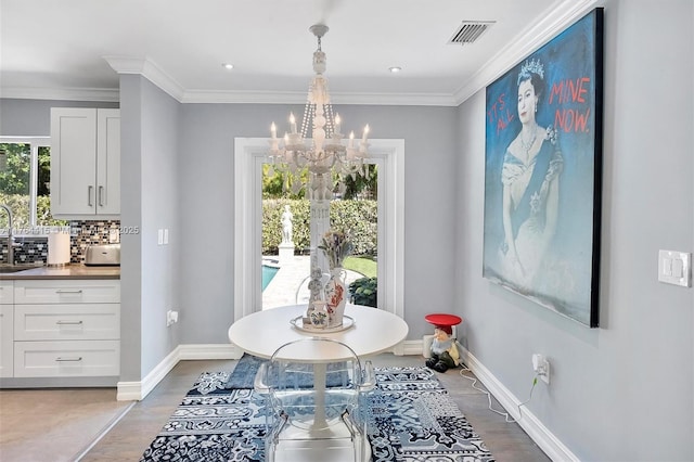 dining area with ornamental molding, baseboards, visible vents, and a chandelier