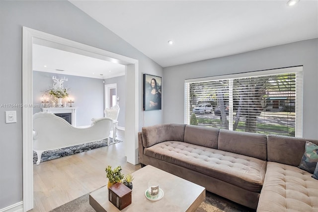 living room featuring recessed lighting, baseboards, lofted ceiling, and wood finished floors