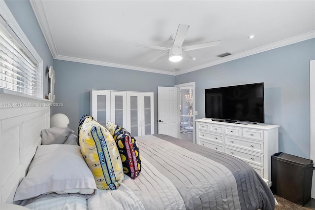 bedroom featuring visible vents, a ceiling fan, and crown molding