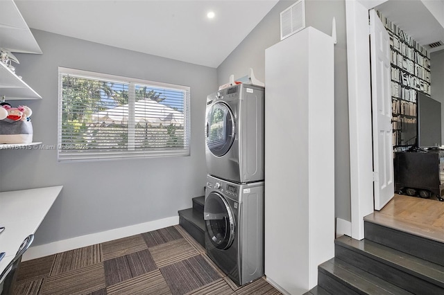 laundry room featuring visible vents, stacked washer and clothes dryer, recessed lighting, baseboards, and laundry area