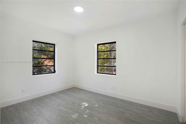 empty room featuring baseboards and wood finished floors