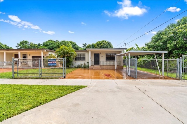 ranch-style house with concrete driveway, a gate, a fenced front yard, and stucco siding