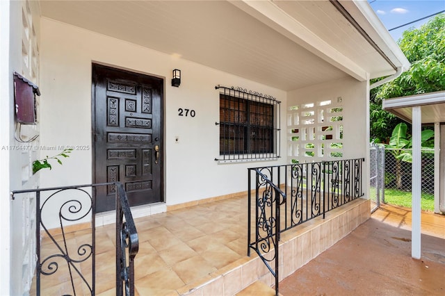 property entrance with stucco siding