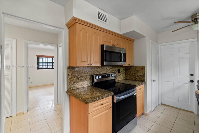 kitchen with visible vents, ceiling fan, light tile patterned floors, decorative backsplash, and appliances with stainless steel finishes