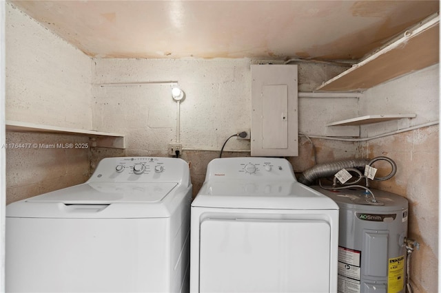 washroom featuring electric panel, laundry area, washing machine and dryer, and water heater