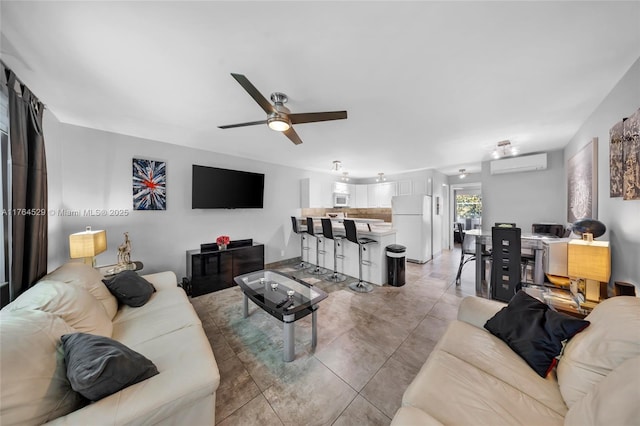 living room with light tile patterned floors, a wall mounted air conditioner, and ceiling fan